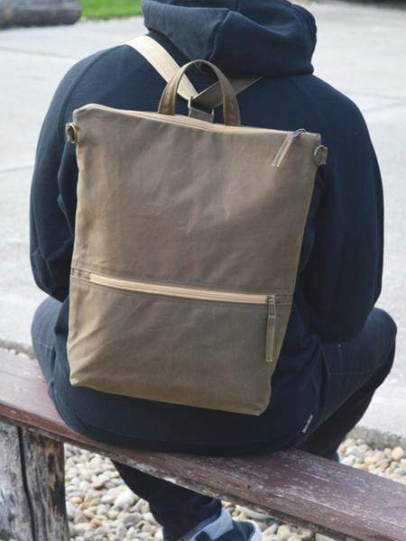 Small waxed canvas backpack in navy blue with rolled top and leather  shoulder straps